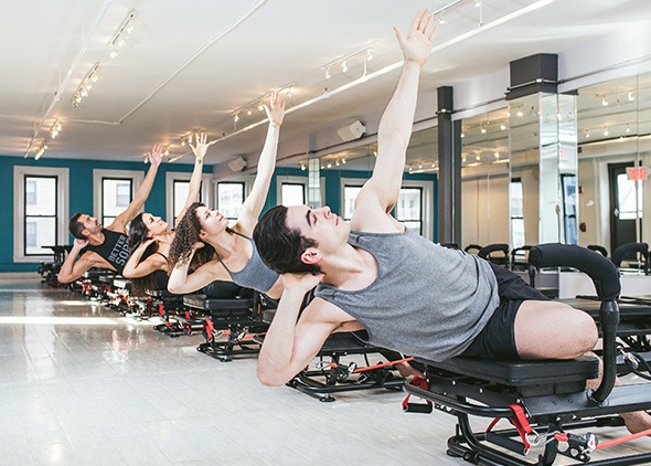 SLT class participants stretching on Megaformers in sync